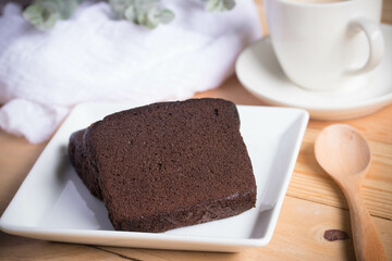 Chocolate cake with coffee in a white plate