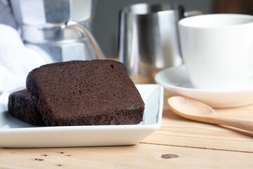 Chocolate cake with coffee in a white plate