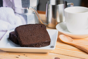 Chocolate cake with coffee in a white plate