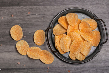 Potato chips in a vintage black tray
