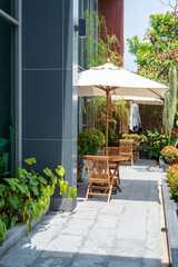 Fototapeta na wymiar Outdoor seat with parasols at hotel balcony with plant decor