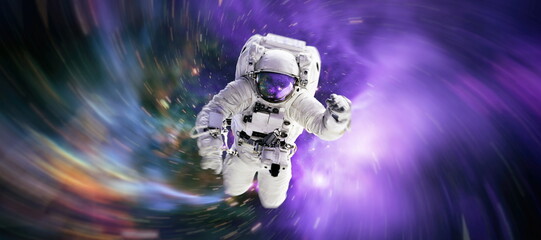 Astronaut in space in the solar system Earth. Blue light on background. Elements of this image...