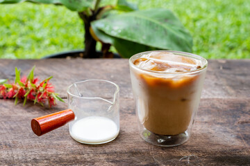 Double glass latte on wooden table background.
