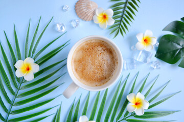 Milk coffee with plumeria flowers and palm leaves on blue. Cozy vocational morning. Coffee break. Relaxing atmosphere. Eco life. Summer style. Hotel room service. Exotic countries.