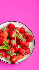 Strawberries on color background.