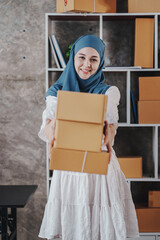 Small Startup Muslim Woman Checking parcels at work, freelancers, salespeople, checking production orders. Pack products to send to customers. Sell Ecommerce Shipping Ideas.