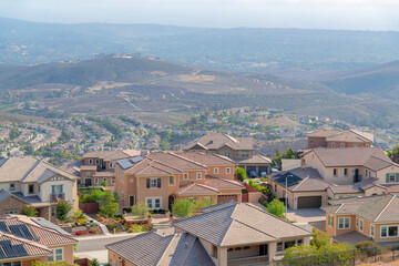 Fototapeta na wymiar High angle view of a hillside fenced residential area at Double Peak Park, San Marcos, California