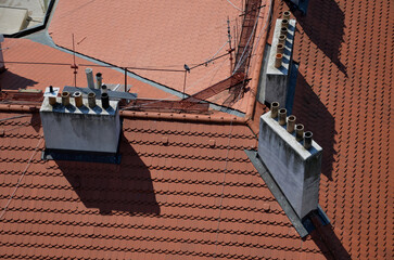 chimneys with several pipes in apartment buildings were swept by several chimney sweeps who walked...