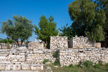 Fototapeta na wymiar Remains of an ancient stone block wall near the sea in Greece.