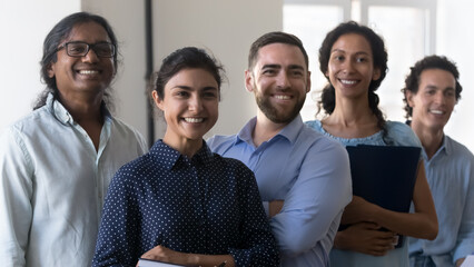 Multi racial company members, enthusiastic business people smile pose in office. Professional advisory, accounting department, group of successful employees portrait, teamwork, racial equality concept