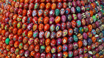 Fototapeta premium Many decorative Easter eggs painted with beautiful bright colors are stacked in the church museum