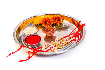 A plate or thali with rice grain and sweets on the occasion of Indian festival