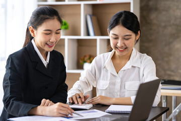 Teamwork process. Two women with laptops in an open space office. Business concept. Data analysis, roadmap, marketing, accounting, auditing.