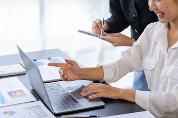 Teamwork process. Two women with laptops in an open space office. Business concept. Data analysis, roadmap, marketing, accounting, auditing.