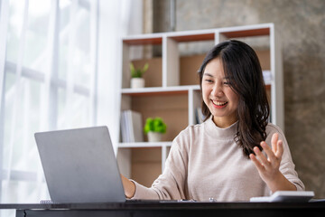Asian businesswoman greeting and meeting online on the Internet through a laptop in an open office business idea Data Analysis, Roadmap, Marketing, Accounting, Auditing