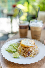 Tasty appetizing classic italian spaghetti pasta with creamy sauce, cheese parmesan and basil on plate on dark table at cafe restuarant.	
