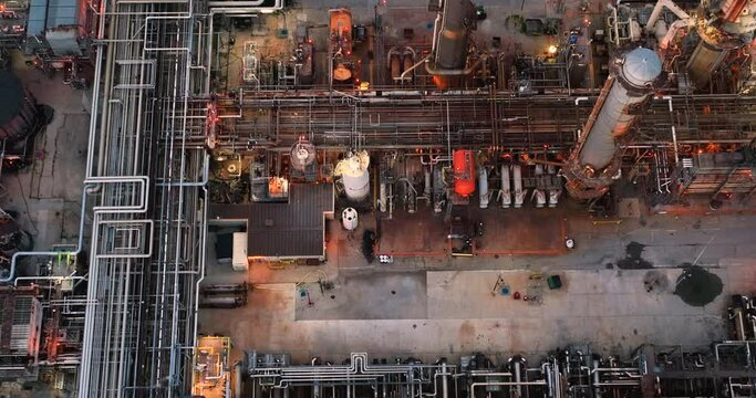 Oil refinery plant production line at dusk. High angle aerial view  