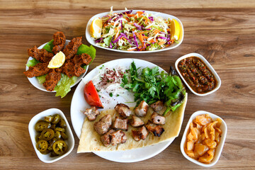 Beef steak grill with rice pilaf, fried potatoes, grilled pepper and tomatoes.Mix Platter with Beef rips, Cutlets, Potatoes and Sauces.