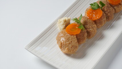 Traditional Jewish Passover food gefilte fish with carrots, horseradish, and lettuce