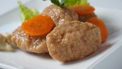 Traditional Jewish Passover food gefilte fish with carrots, horseradish, and lettuce