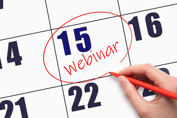 15th day of the month.  Hand writing text WEBINAR and circling the calendar date.
