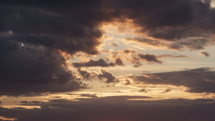 Soft clouds with warm light during summer sunset