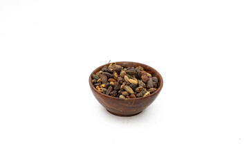 Dry neem or azadirachta indica seed in brown bowl on white background