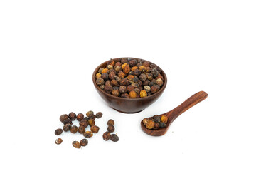 Dry neem or azadirachta indica seed in brown bowl on white background