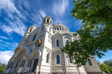 The Naval Cathedral in the city of Kronstadt near St. Petersburg in summer against the background of a blue sky with clouds