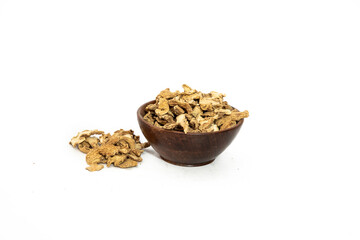 Dry ginger slices or zingiber officinale in bowl isolated on white background