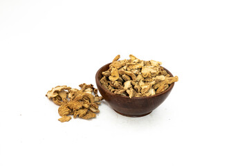 Dry ginger slices or zingiber officinale in bowl isolated on white background