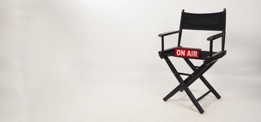 Black director chair and on air box on the chair on white background. studio shot