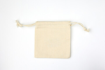 Knitted beige cosmetic bag with ropes for tightening