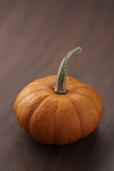 Cute orange pumpkin on wood table with copy space