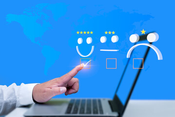 Businessman use laptop pressing smiley face emoticon on virtual touch screen. Assessment Survey...