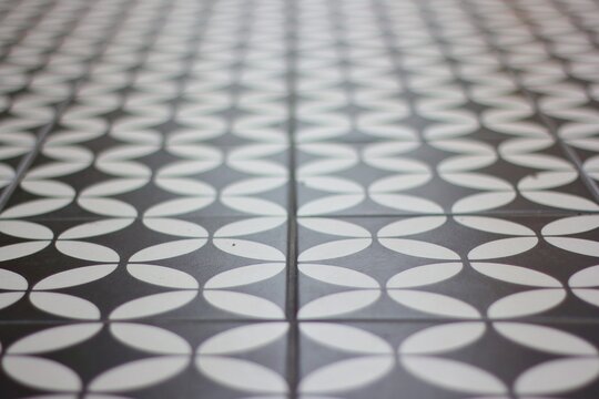 Tiled floor with alternating curves, black and white.
