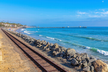 Fototapeta na wymiar Railway near the rocks as seawall from the ocean waves at San Clemente, California
