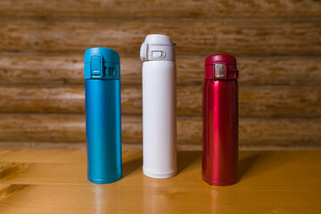 Set of flask thermos of drinks. Reusable thermo water bottle on wooden