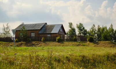 Obraz premium Red bricks house in countryside. Village house.