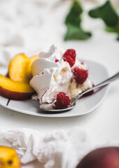 sweet dessert Pavlova cake with raspberries and cream peach