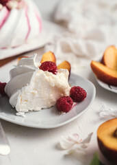 sweet dessert Pavlova cake with raspberries and cream peach