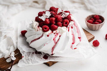sweet dessert Pavlova cake with raspberries and cream peach