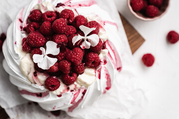 sweet dessert Pavlova cake with raspberries and cream peach
