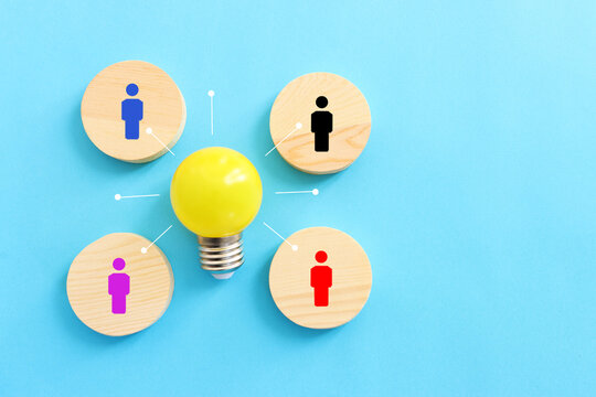Education concept image. Creative idea and innovation. light bulb metaphor over blue background, wooden cubes and people icons