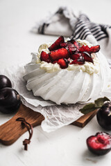 dessert Pavlova cake with cherry plum