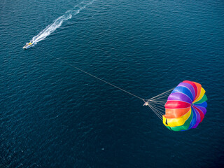 Aerial view of the boat and parachute in the sea resort