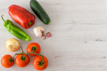 Background of different vegetables, tomato, peppers, cucumber, garlic and onion with copy space
