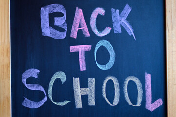 Blackboard with a text written in colored chalk that says Back to School