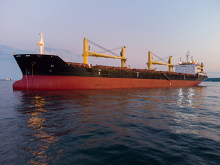 Large general cargo ship tanker bulk carrier, aerial view at night.