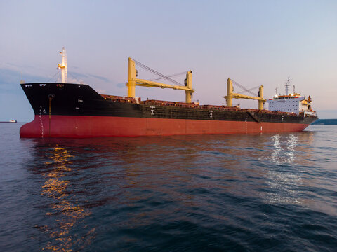 Large general cargo ship tanker bulk carrier, aerial view at night.